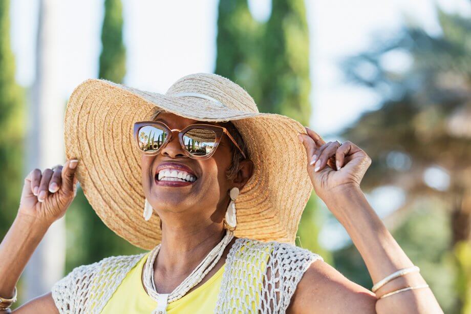 Smiling woman in sunhat and sunglasses