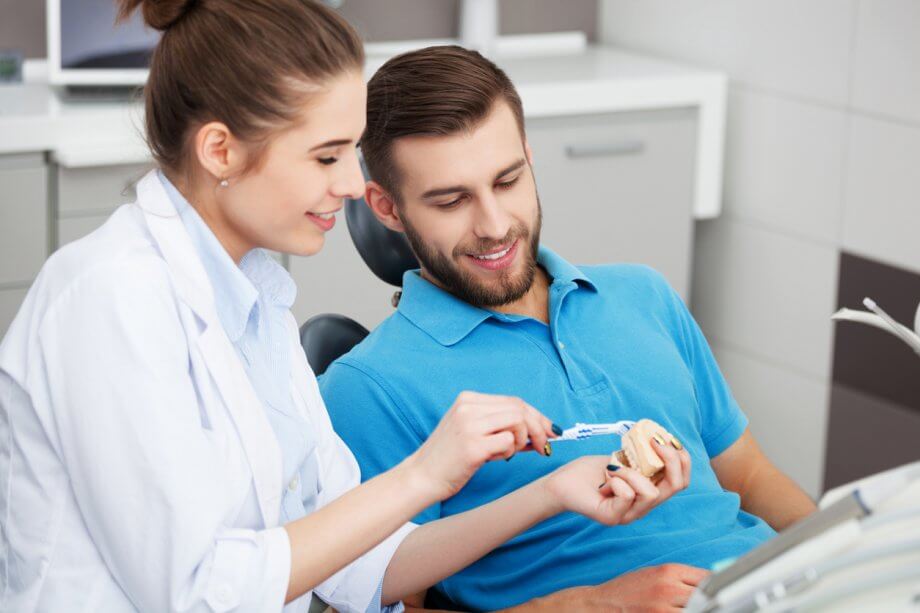 Dentist Demonstrating Healthy Brushing Techniques