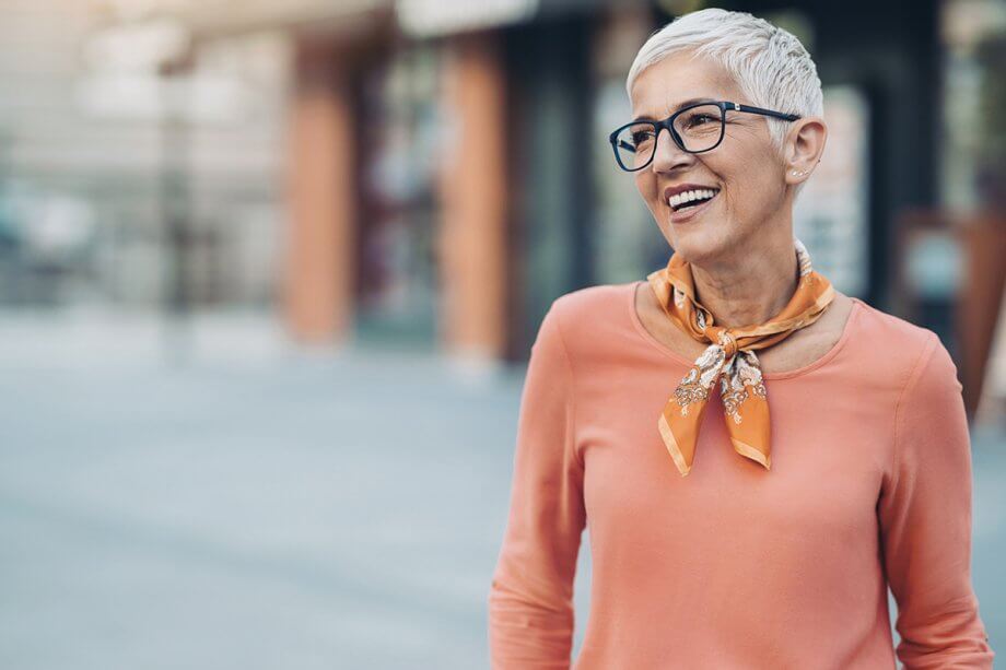 older woman with glasses and smiling