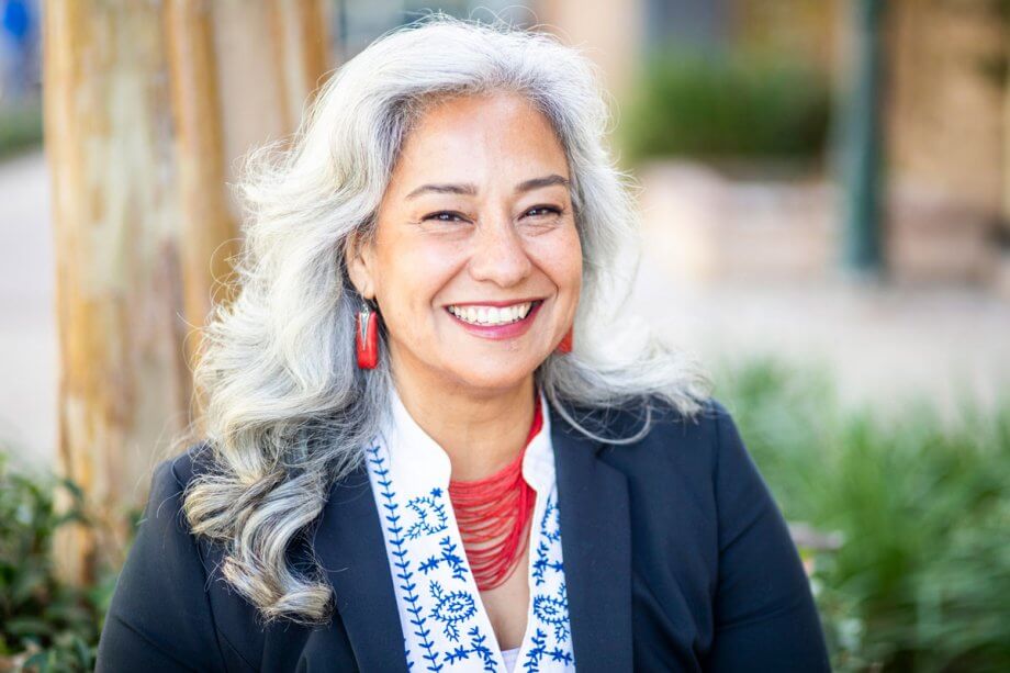 mature woman smiling with dental implants