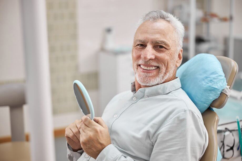 Older man smiling in dental office