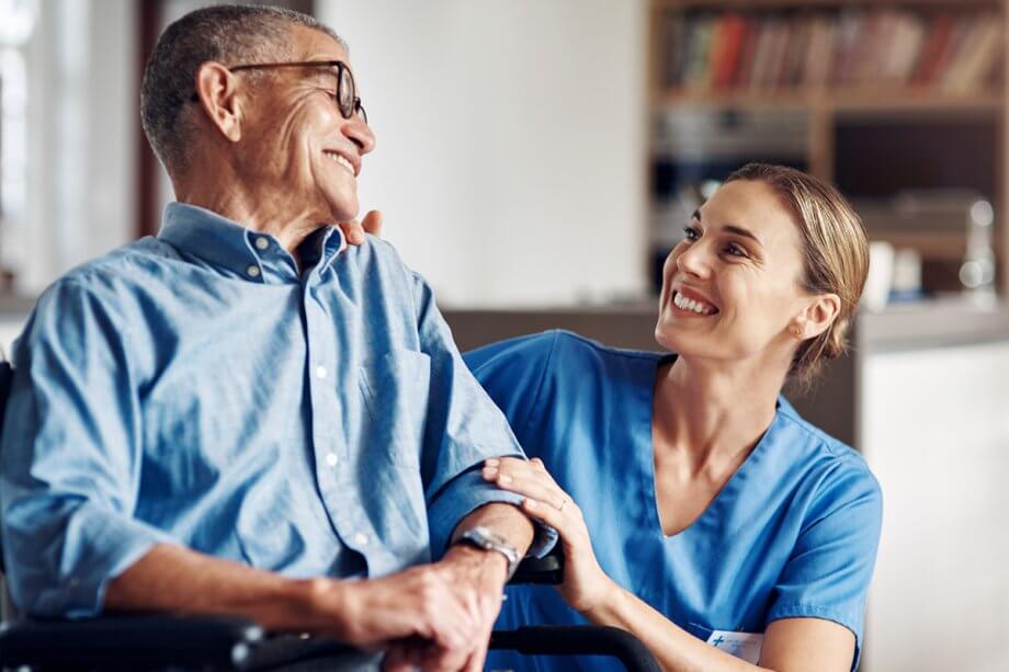 dental assistant talking to mature man